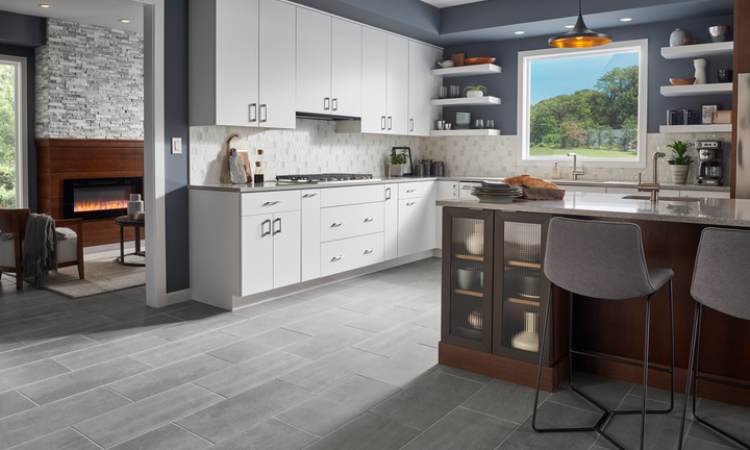 Marble tile by Emser tile in kitchen with white cabinets and wood counter